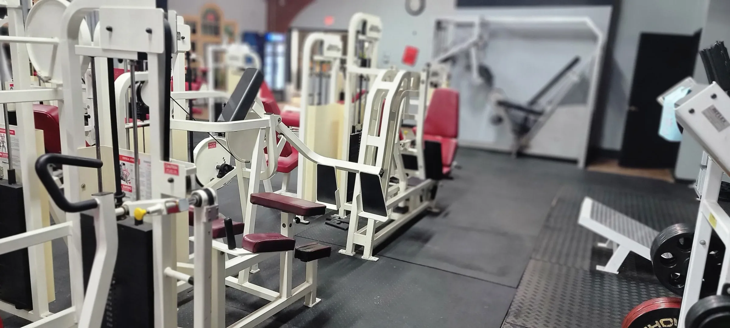 Wide view of strength training area at Next Level Fitness Moline
