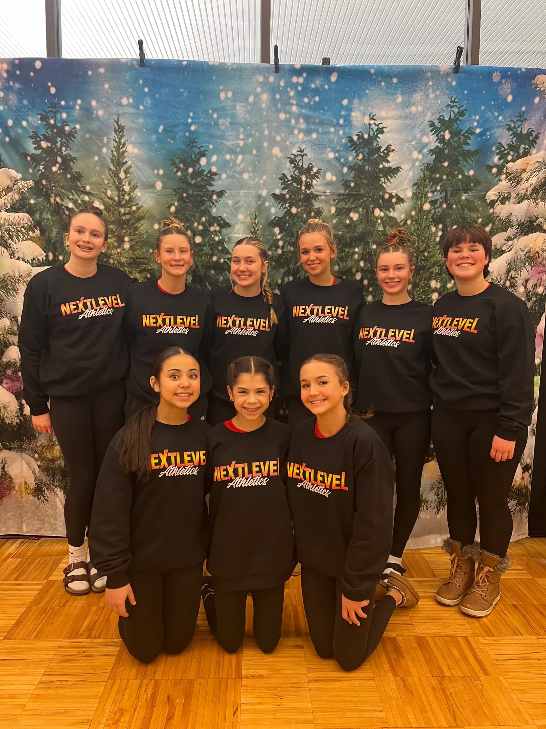 Next Level gymnastics team together at a winter invitational meet